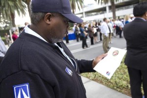 Anthony McCollough, an OCTA coach operator for the past 16 years who also served in the Marines for eight years, takes a moment to look at a pin he received from OCTA in honor of his years of military service and his continued public service through OCTA. Each veteran received a pin that included an American flag, their branch of military service and the OCTA logo.